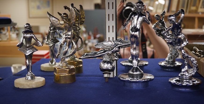 Five chrome car mascots in the form of female dancing figures, three mounted on threaded radiator caps, one with a registration number: 675619, one a stylised Art Deco winged female figure astride a globe. Condition - fa